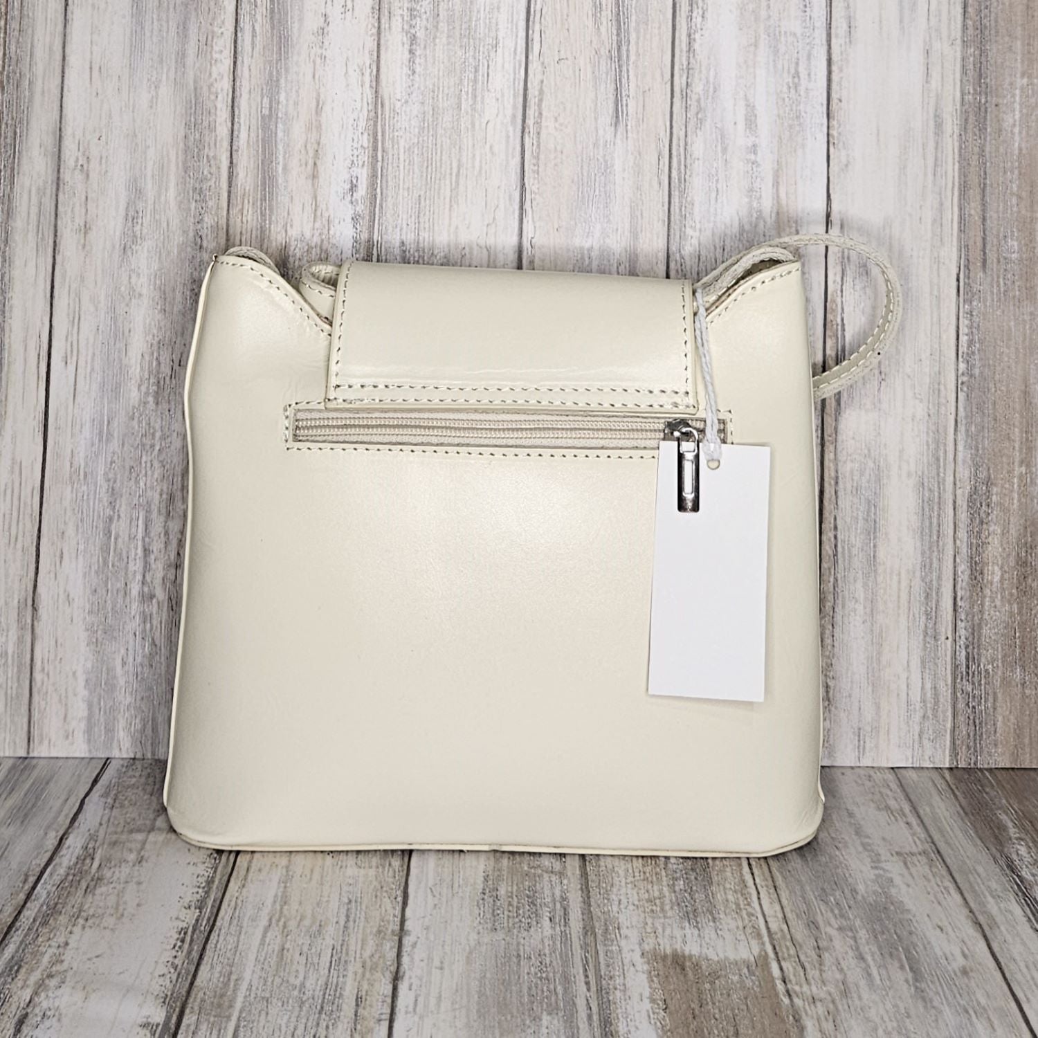 Crafted with Italian leather, this cross body bag features a magnetic dot and zip closure and an adjustable strap for a stylish look.       Back Zip Pocket   Internal Slip Pocket   Silver Hardware   H20cm x W24cm x D6cm