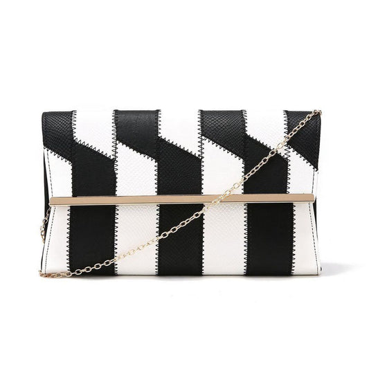 Take a trip back in time with our Kira Patchwork Foldover Bag! This 1960s inspired clutch bag features a unique patchwork design in classic black and white. Conveniently switch between a stylish statement piece and a functional crossbody using the detachable chain strap. Elevate any outfit with this versatile must-have accessory.