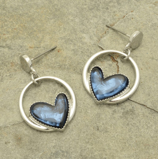 These statement earrings are a must-have for any stylish night out. The beautiful blue hearts, backed with aluminium foil, add depth and vibrancy, and look stunning against the sleek silver hoop.  2cm hoop drop from a silver bead,  and a silicon butterfly fastening.