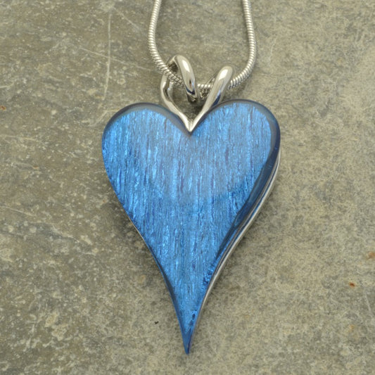 This beautiful Blue Necklace is the perfect way to add subtle yet stylish sparkle to any outfit. Crafted with a lustrous foil-backed resin, the striking heart pendant is perfect for making a subtle statement. Wear it and dazzle!