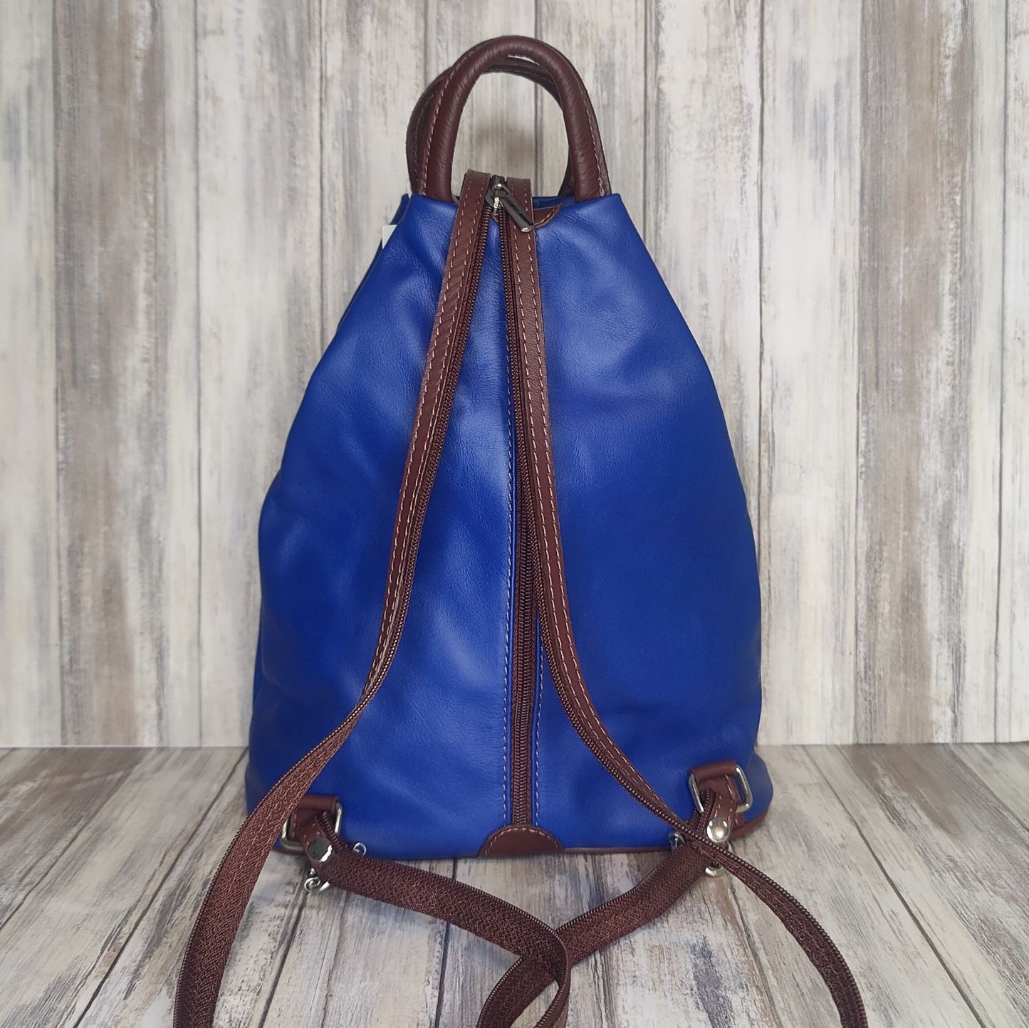 A beautiful soft and lightweight leather Italian backpack. These versatile backpacks can be carried in three ways, either by the loop handle at the top, over one shoulder, or by unzipping the strap and wearing as a classic backpack. Each bag is fully lined and comes in such a variety of gorgeous colours so you won't have any trouble choosing your favourite!  Front, back and inside pockets.   w25cm x h31cm x d14 cm 