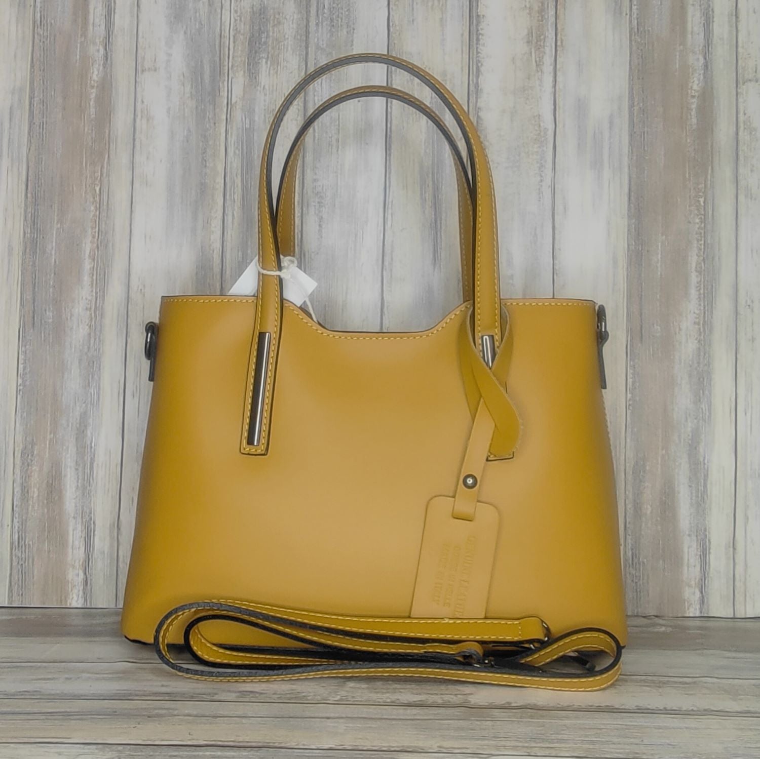 Elevate your style with this stunning Italian leather double compartment handbag.  Its soft yet structured design looks beautiful and feels equally beautiful to wear. This is a classic design that will match with any outfit and is the perfect size for all your essential items. Get ready to make a statement with this fashionable and functional addition to your wardrobe.  We love this bag!