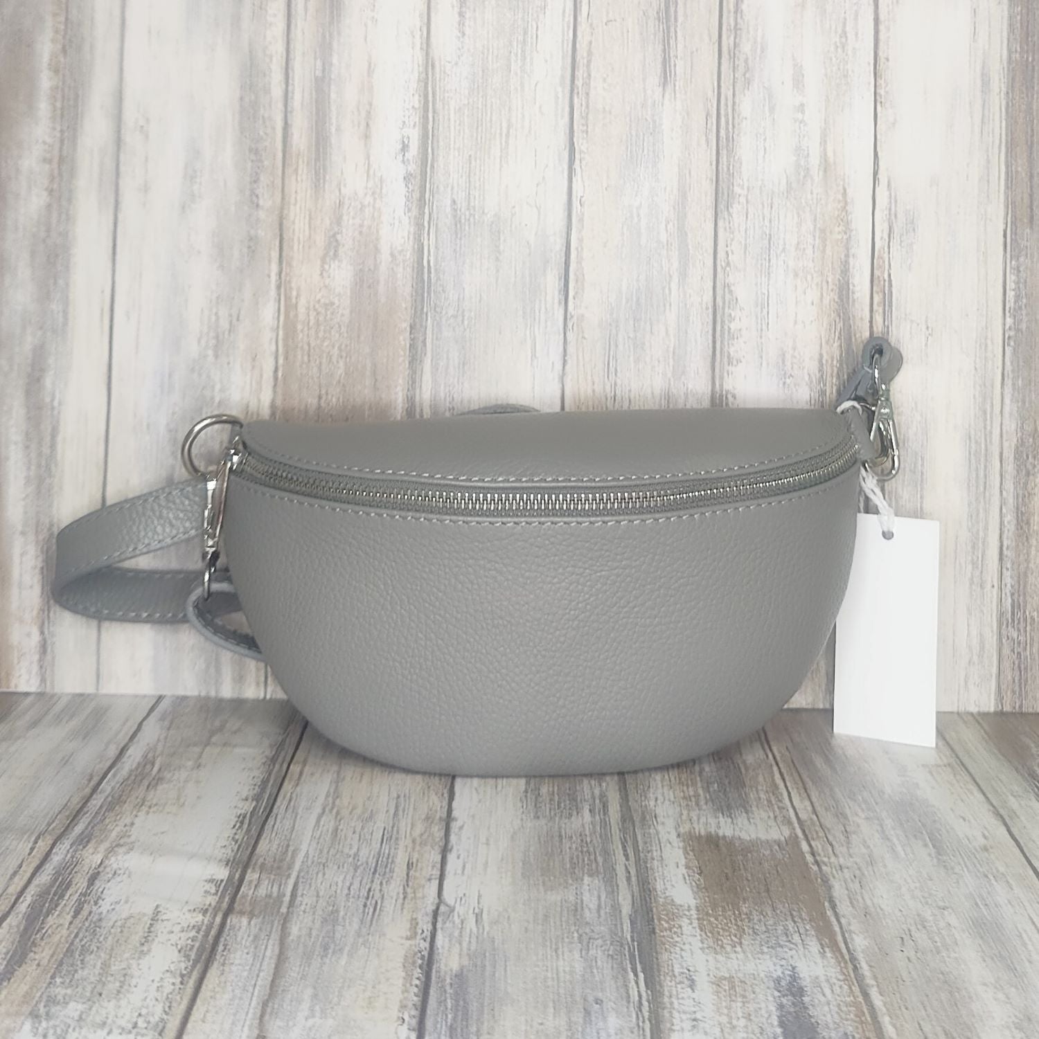 Made with soft  Italian leather, our Sling Bag/Bum Bag is the perfect combination of chic and practical. Enjoy easy access to your essentials when you're on the go, and elevate your look with confidence!  Top Zip Closure  Internal pocket  Silver Hardware  L:12cm x W:26cm x D:9cm