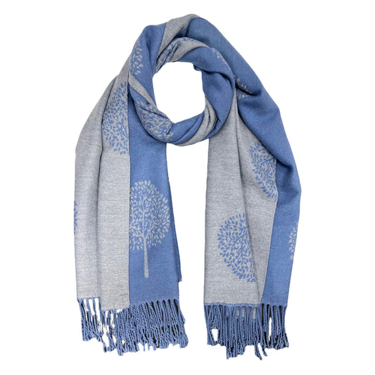 This beautiful, reversible scarf is crafted from a luxurious cashmere blend, featuring a striking denim hue and elegantly finished with tassels. The  tree of life print adds a sophisticated touch to this timeless piece, making it a perfect cozy addition to your look.     80% Viscose, 20% Cashmere  L: 180cm x W: 65cm 