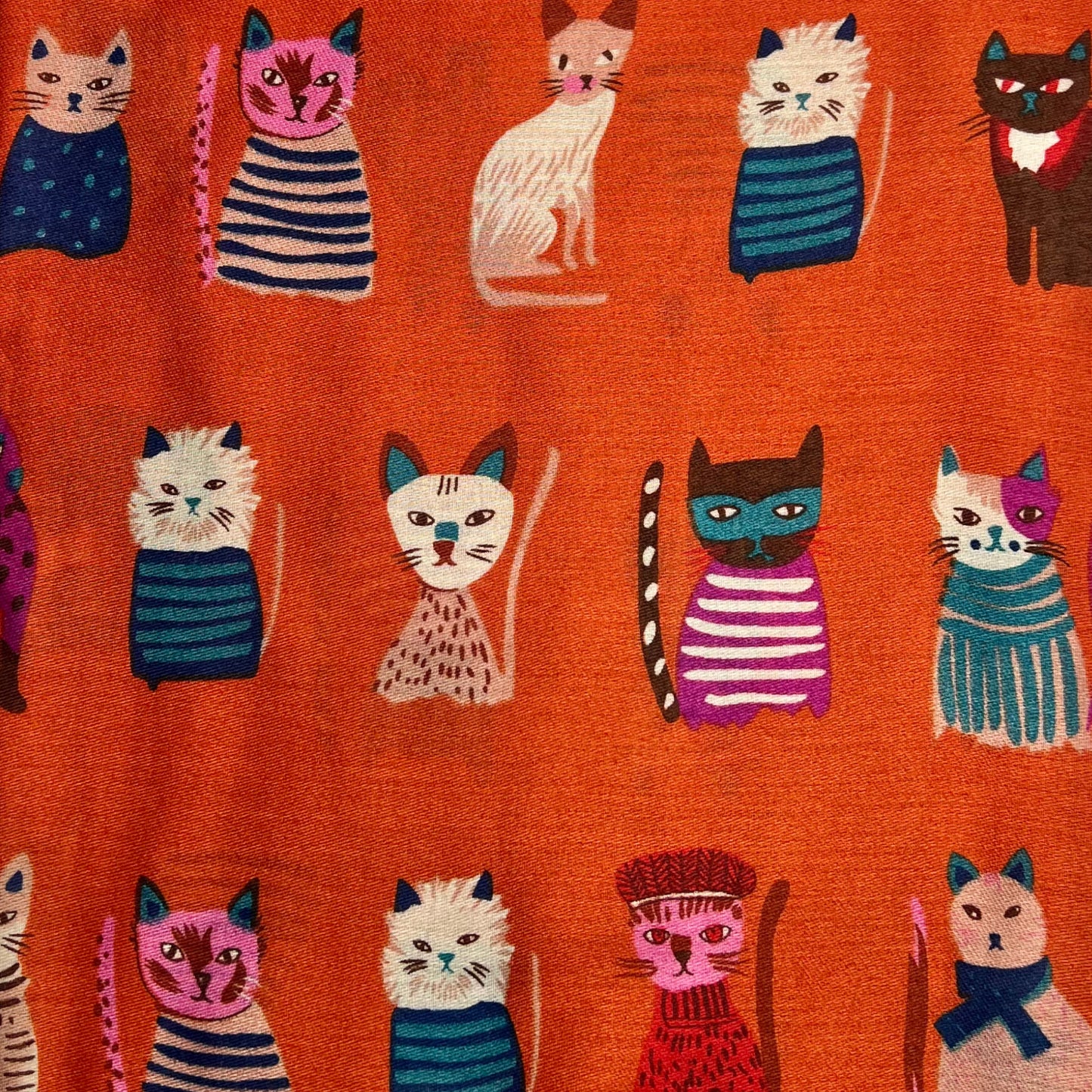 This Cat Costumes Print Scarf is the perfect way to add an element of fun and whimsy to any look. Crafted with a cotton blend, fringed at each end, and featuring an adorable print of cats wearing costumes, this scarf will make a great statement piece.