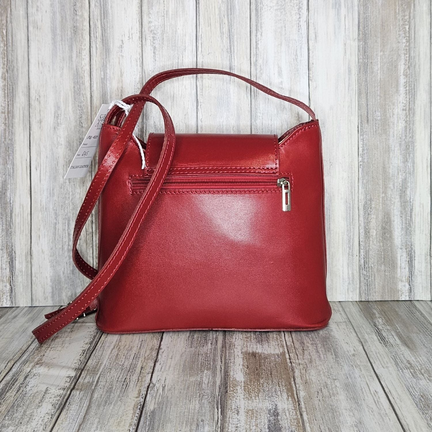 Crafted with Italian leather, this cross body bag features a magnetic dot and zip closure and an adjustable strap for a stylish look.       Back Zip Pocket   Internal Slip Pocket   Silver Hardware   H20cm x W24cm x D6cm