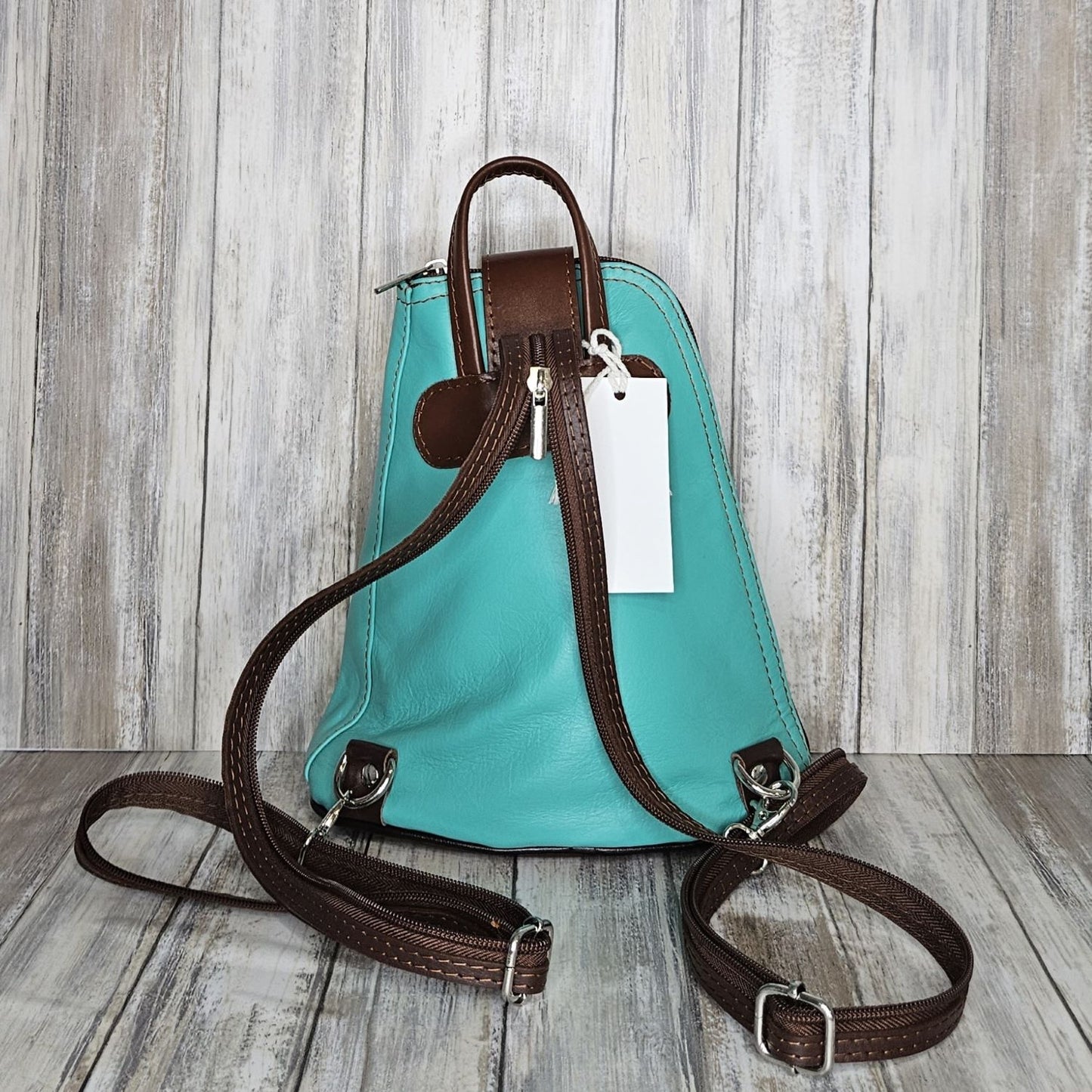 Another beautifully soft and lightweight leather Italian backpack, but this time a smaller version of our large backpack. This small backpack is equally as versatile and can be worn in the same main three ways, either by the loop handle at the top, over one shoulder, or by unzipping the strap and wearing as a classic backpack. You can also unclip the straps of these smaller ones and wear them as a cross body!  Each bag is fully lined with front, back and inside pockets.   W22cm x D23cm x H12cm