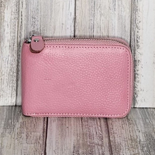This classic leather card holder features 12 card slots for easy organization. It also includes a single zip and enough space to store a few notes or receipts. Made from premium pebbled leather, it is lightweight yet durable, offering a perfect balance of style and convenience.