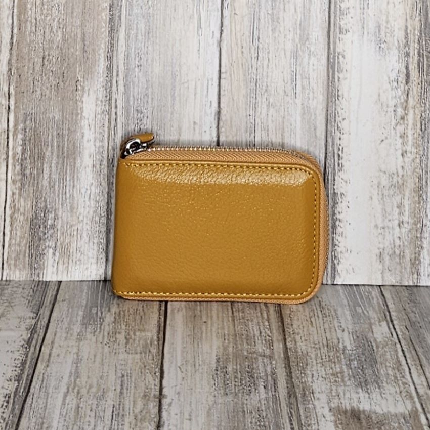 This classic leather card holder features 12 card slots for easy organization. It also includes a single zip and enough space to store a few notes or receipts. Made from premium pebbled leather, it is lightweight yet durable, offering a perfect balance of style and convenience.  L:11cm x W:7cm x D:2.5cm