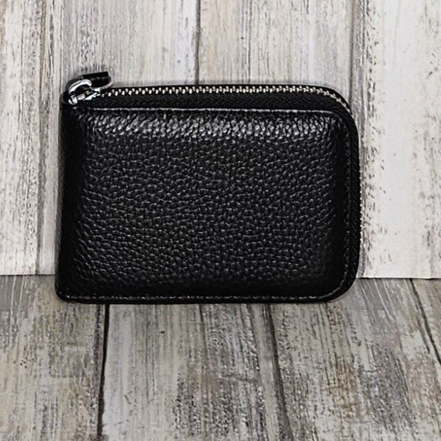 This classic leather card holder features 12 card slots for easy organization. It also includes a single zip and enough space to store a few notes or receipts. Made from premium pebbled leather, it is lightweight yet durable, offering a perfect balance of style and convenience.