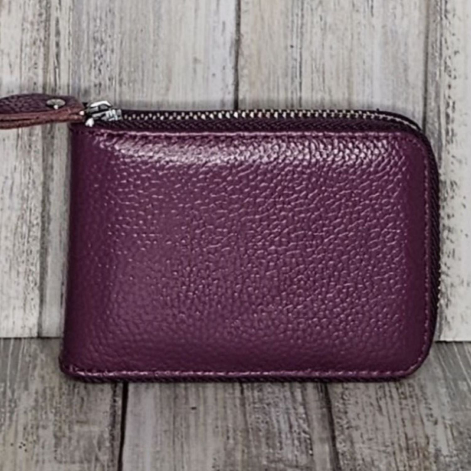 This classic leather card holder features 12 card slots for easy organization. It also includes a single zip and enough space to store a few notes or receipts. Made from premium pebbled leather, it is lightweight yet durable, offering a perfect balance of style and convenience.