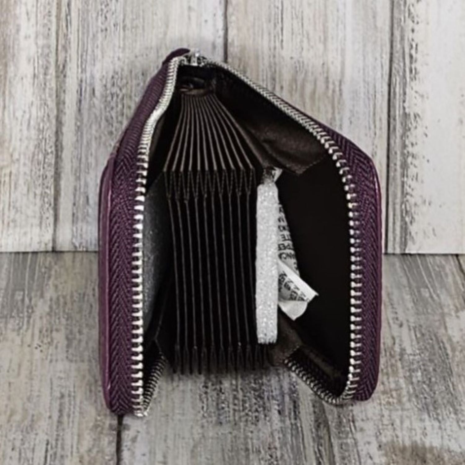 This classic leather card holder features 12 card slots for easy organization. It also includes a single zip and enough space to store a few notes or receipts. Made from premium pebbled leather, it is lightweight yet durable, offering a perfect balance of style and convenience.