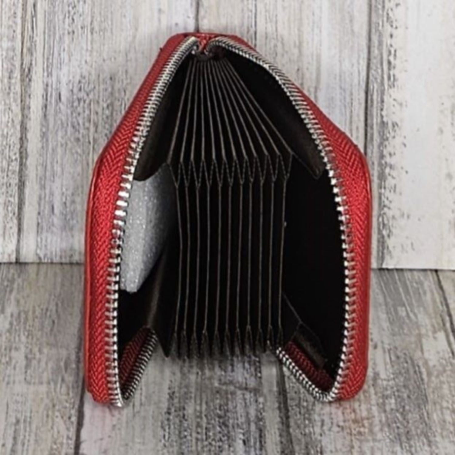 This classic leather card holder features 12 card slots for easy organization. It also includes a single zip and enough space to store a few notes or receipts. Made from premium pebbled leather, it is lightweight yet durable, offering a perfect balance of style and convenience.