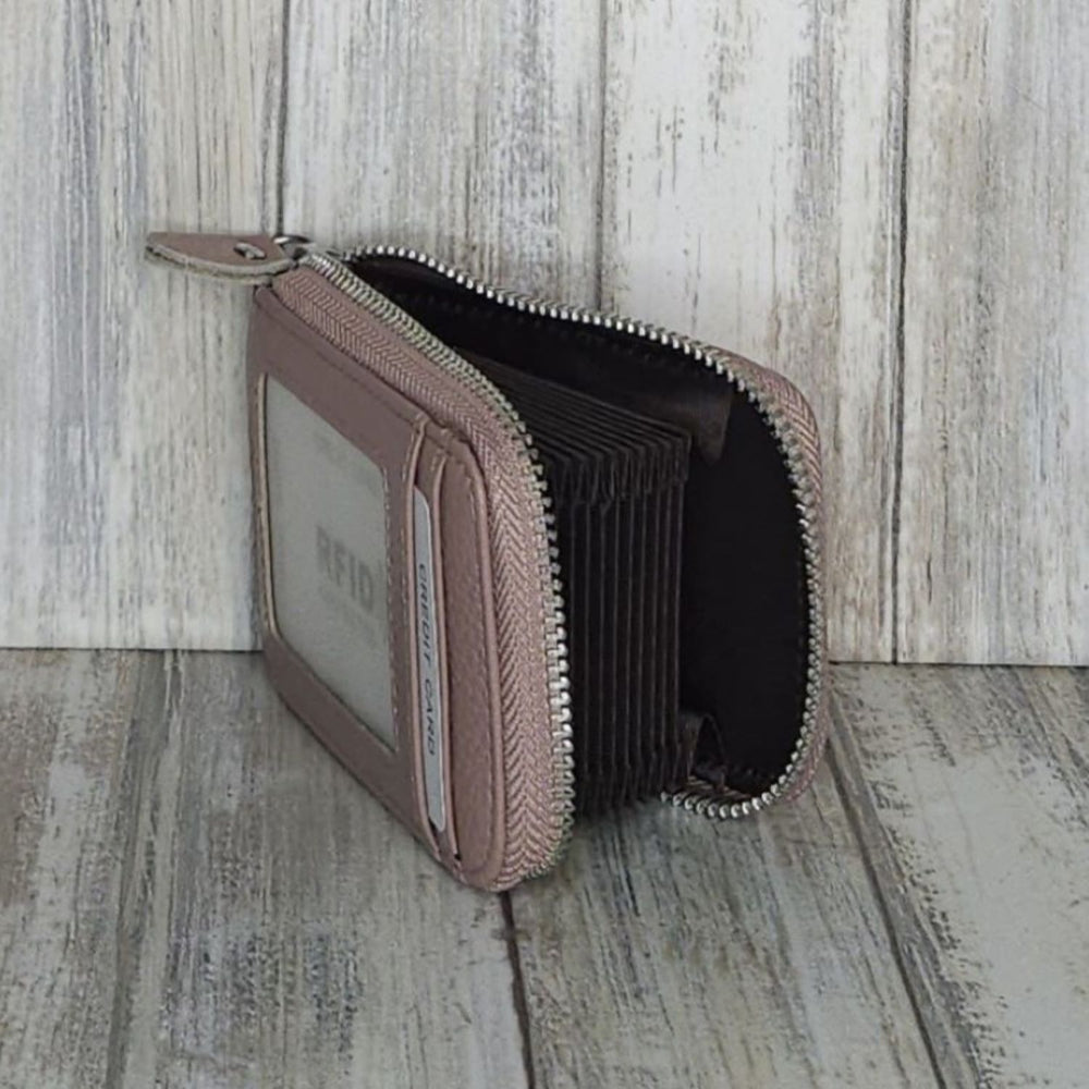 This classic leather card holder features 12 card slots for easy organization. It also includes a single zip and enough space to store a few notes or receipts. Made from premium pebbled leather, it is lightweight yet durable, offering a perfect balance of style and convenience.