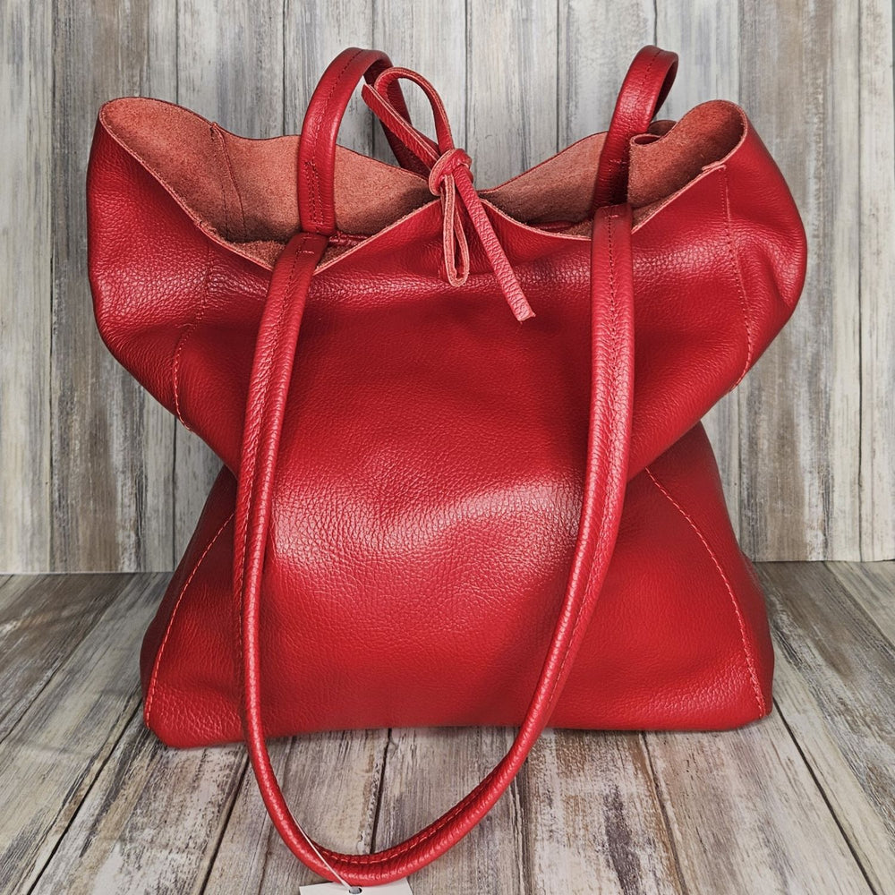 Experience luxury and organization with our pebbled leather Tote Bag! Made with soft Italian leather, this large tote features a convenient internal zip pocket and a stylish leather drawstring closure. Stay on-trend and chic with our fabulous red bag!