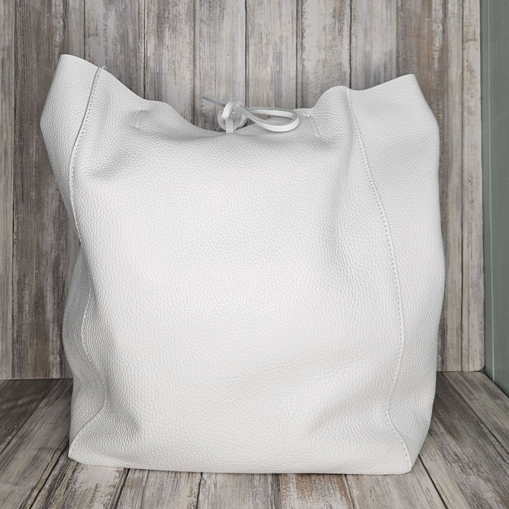 Experience luxury and organization with our pebbled leather Tote Bag! Made with soft Italian leather, this large tote features a convenient internal zip pocket and a stylish leather drawstring closure. Stay on-trend and chic with our fabulous white bag!