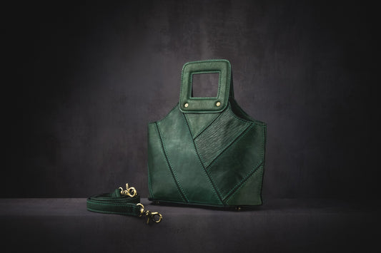 Alizay is a beautiful green leather handbag with an absolutely stunning stitched exterior. The attention to style is reflected in small details such as covering the magnetic closure with a thin layer of leather. The interior is a super soft microfibre lining with slots for cards, lipstick and mobile phone. It also has a zipped pocket for valuables. The bottom of the Alizay bag is studded so you can put her down without worrying about scuffs or damage.  Adjustable leather shoulder strap.