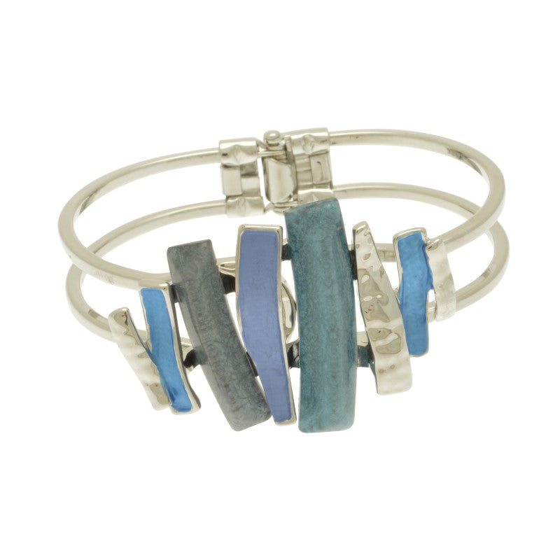 This stylish blue layered mix bracelet is the perfect addition to any outfit. Featuring a fresh touch of silver in a hinged style, this bracelet is designed to fit all sizes of wrist. The beautiful combination of blue resin and paint will be sure to turn heads!