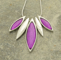 This beautiful leaf necklace is crafted of deep purple resin and tin foil for a unique, eye-catching finish. The vibrant hue is glossy and subtly shimmering, giving the piece an elegant, one-of-a-kind look.  The pendant comes with a 41cm snake chain and 8cm extender, secured with a lobster clasp.