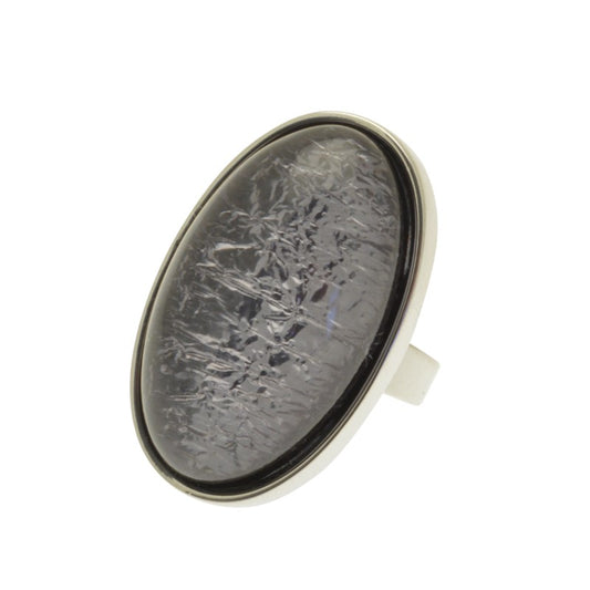 This stylish Miss Milly Chunky Smoke Grey Ring can be worn with any outfit. Its resin construction with a foil backing ensures a glossy finish, while the adjustable band makes it versatile and comfortable to wear. Its size measures 3.3cm long and 2cm wide.