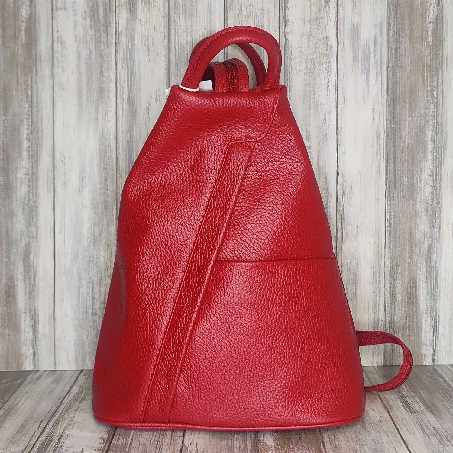 A beautiful soft and lightweight pebbled leather Italian backpack. These versatile backpacks can be carried in three ways, either by the loop handle at the top, over one shoulder, or by unzipping the strap and wearing as a classic backpack. Each bag is fully lined and comes in such a variety of gorgeous colours so you won't have any trouble choosing your favourite!  Front, back and inside pockets.  w25cm x h31cm x d14 cm 