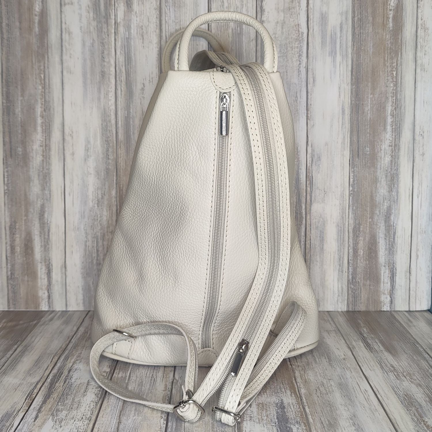 A beautiful soft and lightweight pebbled leather Italian backpack. These versatile backpacks can be carried in three ways, either by the loop handle at the top, over one shoulder, or by unzipping the strap and wearing as a classic backpack. Each bag is fully lined and comes in such a variety of gorgeous colours so you won't have any trouble choosing your favourite!  Front, back and inside pockets.  w25cm x h31cm x d14 cm 