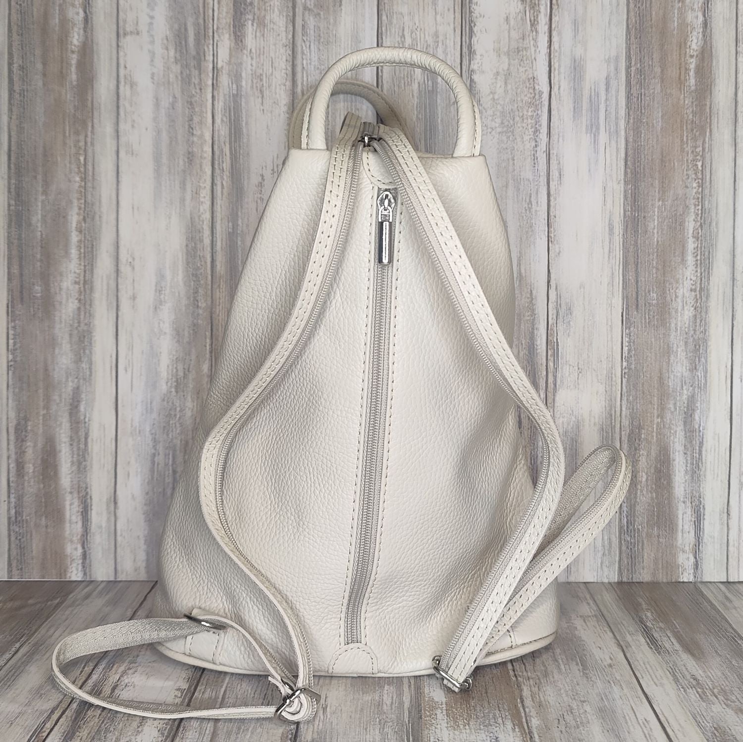 A beautiful soft and lightweight pebbled leather Italian backpack. These versatile backpacks can be carried in three ways, either by the loop handle at the top, over one shoulder, or by unzipping the strap and wearing as a classic backpack. Each bag is fully lined and comes in such a variety of gorgeous colours so you won't have any trouble choosing your favourite!  Front, back and inside pockets.  w25cm x h31cm x d14 cm 