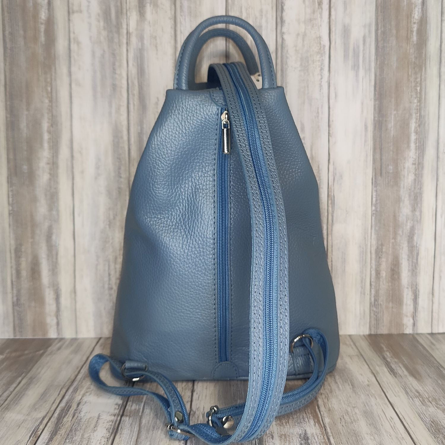 A beautiful soft and lightweight pebbled leather Italian backpack. These versatile backpacks can be carried in three ways, either by the loop handle at the top, over one shoulder, or by unzipping the strap and wearing as a classic backpack. Each bag is fully lined and comes in such a variety of gorgeous colours so you won't have any trouble choosing your favourite!  Front, back and inside pockets.  w25cm x h31cm x d14 cm 