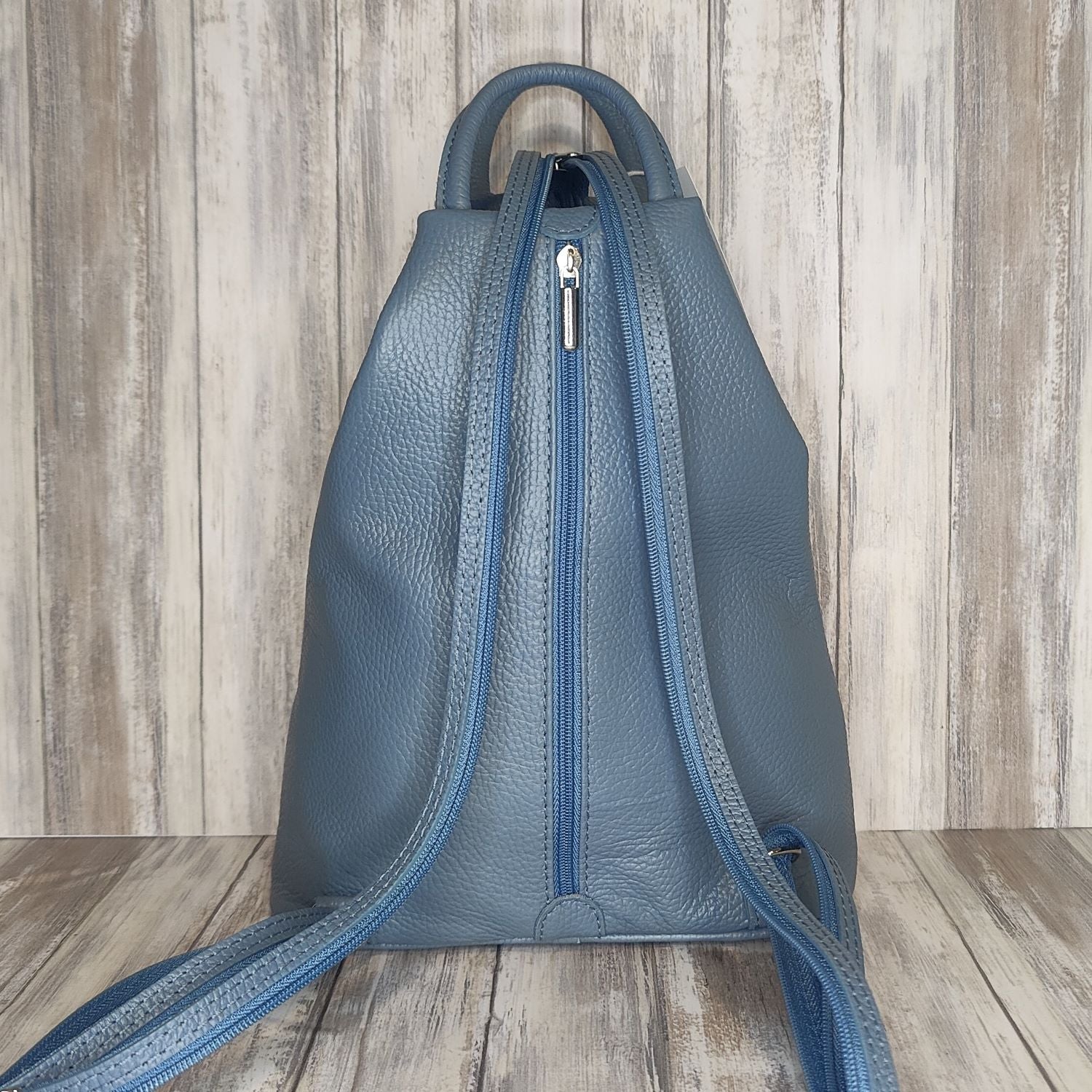 A beautiful soft and lightweight pebbled leather Italian backpack. These versatile backpacks can be carried in three ways, either by the loop handle at the top, over one shoulder, or by unzipping the strap and wearing as a classic backpack. Each bag is fully lined and comes in such a variety of gorgeous colours so you won't have any trouble choosing your favourite!  Front, back and inside pockets.  w25cm x h31cm x d14 cm 