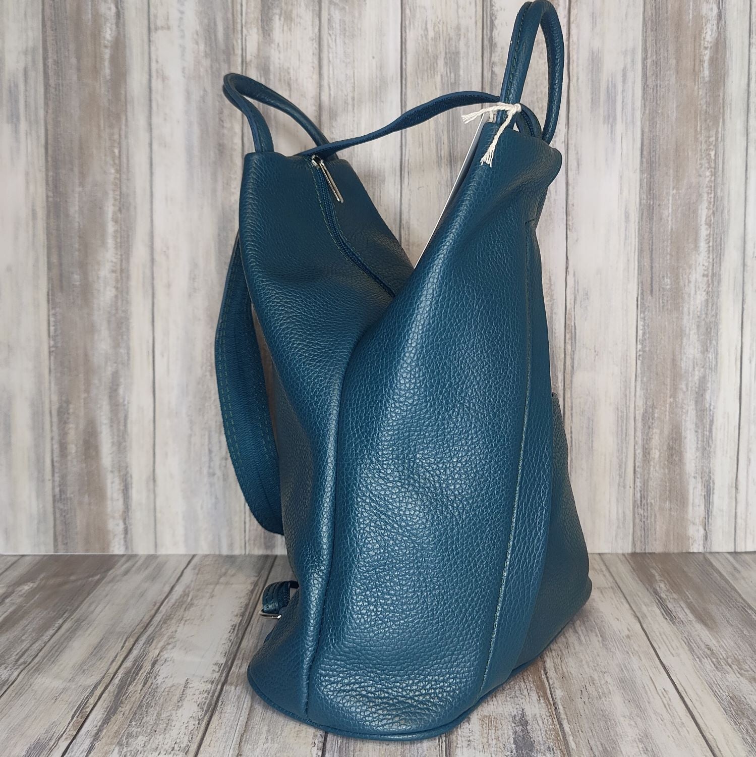 A beautiful soft and lightweight pebbled leather Italian backpack. These versatile backpacks can be carried in three ways, either by the loop handle at the top, over one shoulder, or by unzipping the strap and wearing as a classic backpack. Each bag is fully lined and comes in such a variety of gorgeous colours so you won't have any trouble choosing your favourite!  Front, back and inside pockets.  w25cm x h31cm x d14 cm 