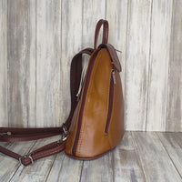 Another beautifully soft and lightweight leather Italian backpack, but this time a smaller version of our large backpack. This small backpack is equally as versatile and can be worn in the same main three ways, either by the loop handle at the top, over one shoulder, or by unzipping the strap and wearing as a classic backpack. You can also unclip the straps of these smaller ones and wear them as a cross body!  Each bag is fully lined with front, back and inside pockets.   w22cm x d23cm x h12cm