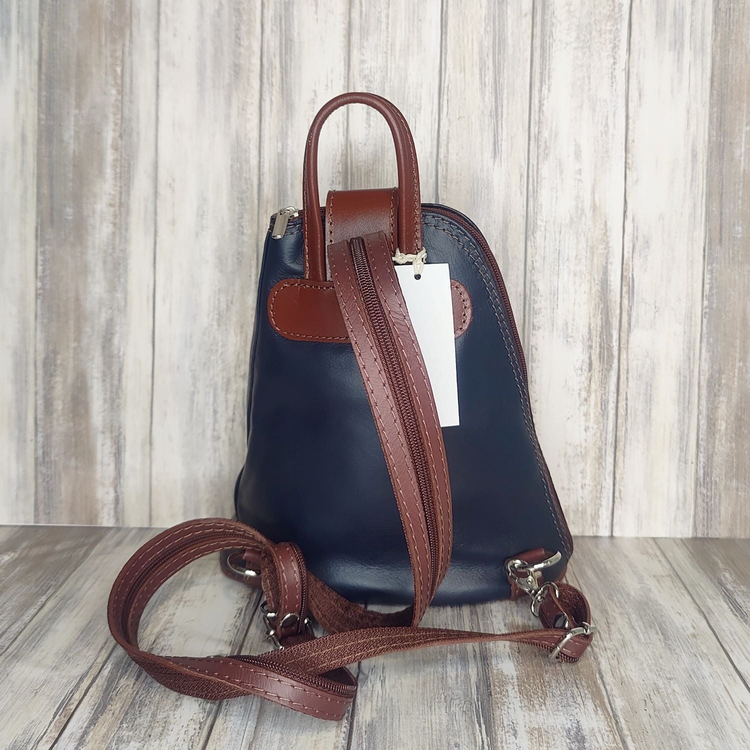 Another beautifully soft and lightweight leather Italian backpack, but this time a smaller version of our large backpack. This small backpack is equally as versatile and can be worn in the same main three ways, either by the loop handle at the top, over one shoulder, or by unzipping the strap and wearing as a classic backpack. You can also unclip the straps of these smaller ones and wear them as a cross body!  Each bag is fully lined with front, back and inside pockets.   w22cm x d23cm x h12cm