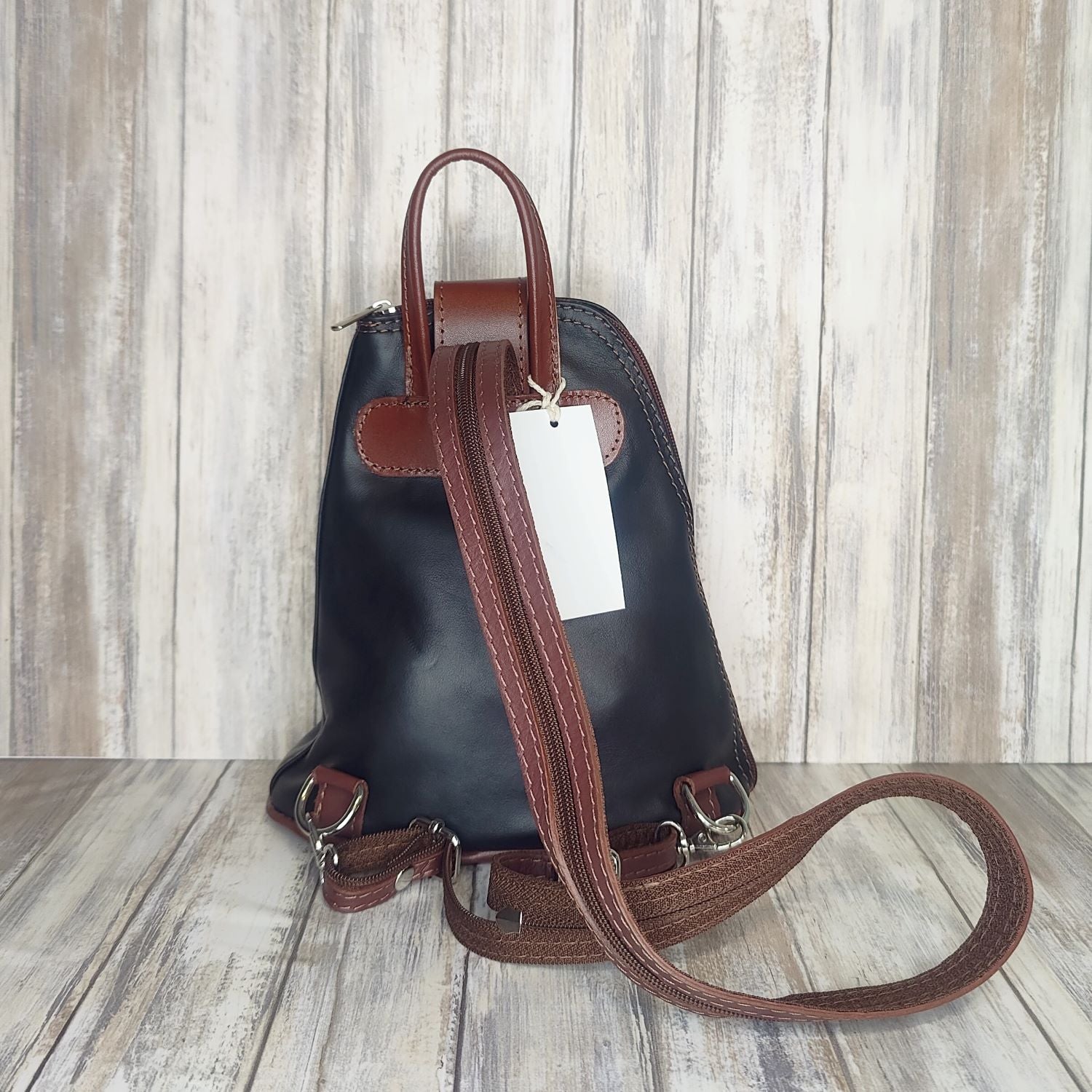 Another beautifully soft and lightweight leather Italian backpack, but this time a smaller version of our large backpack. This small backpack is equally as versatile and can be worn in the same main three ways, either by the loop handle at the top, over one shoulder, or by unzipping the strap and wearing as a classic backpack. You can also unclip the straps of these smaller ones and wear them as a cross body!  Each bag is fully lined with front, back and inside pockets.   w22cm x d23cm x h12cm