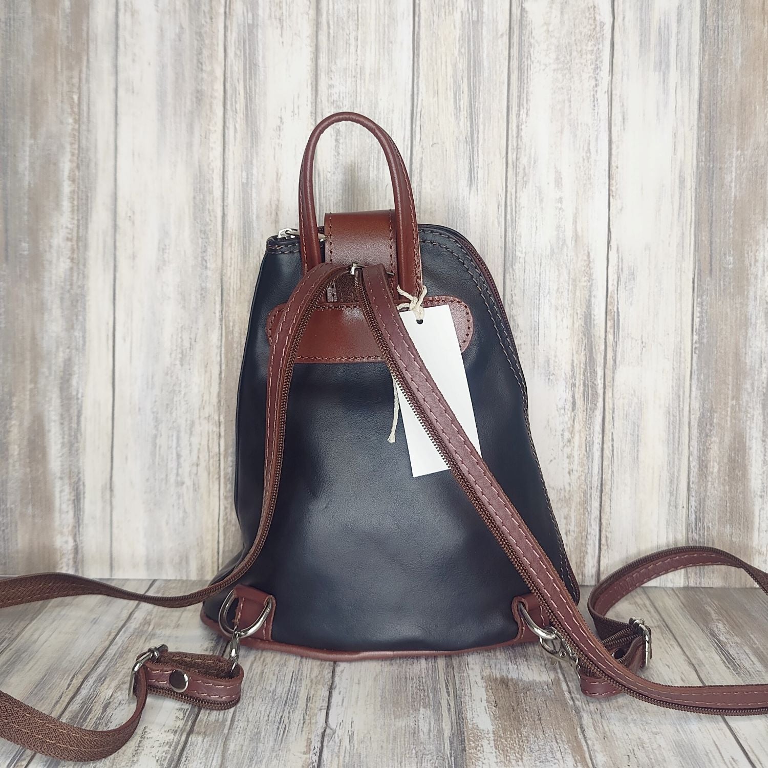 Another beautifully soft and lightweight leather Italian backpack, but this time a smaller version of our large backpack. This small backpack is equally as versatile and can be worn in the same main three ways, either by the loop handle at the top, over one shoulder, or by unzipping the strap and wearing as a classic backpack. You can also unclip the straps of these smaller ones and wear them as a cross body!  Each bag is fully lined with front, back and inside pockets.   w22cm x d23cm x h12cm