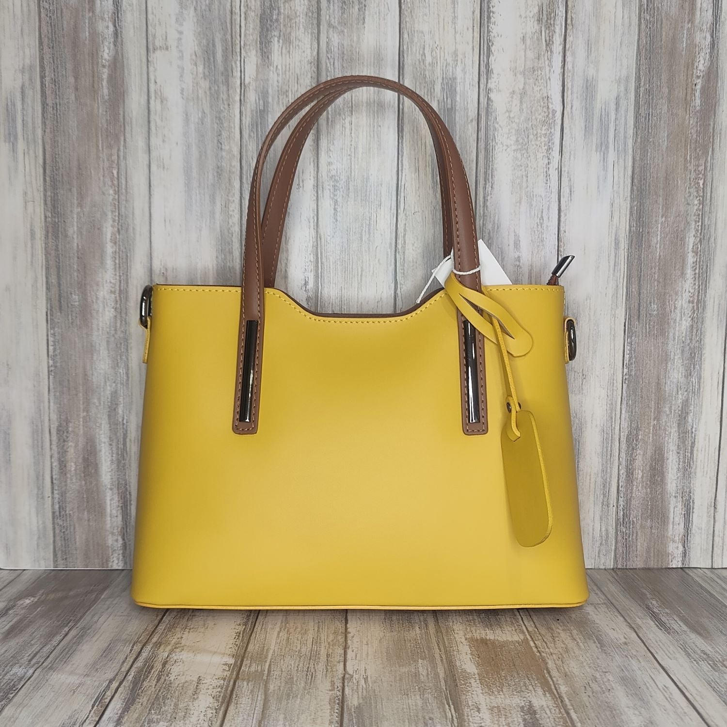 Elevate your style with this stunning Italian leather double compartment handbag.  Its soft yet structured design looks beautiful and feels equally beautiful to wear. This is a classic design that will match with any outfit and is the perfect size for all your essential items. Get ready to make a statement with this fashionable and functional addition to your wardrobe.  We love this bag!