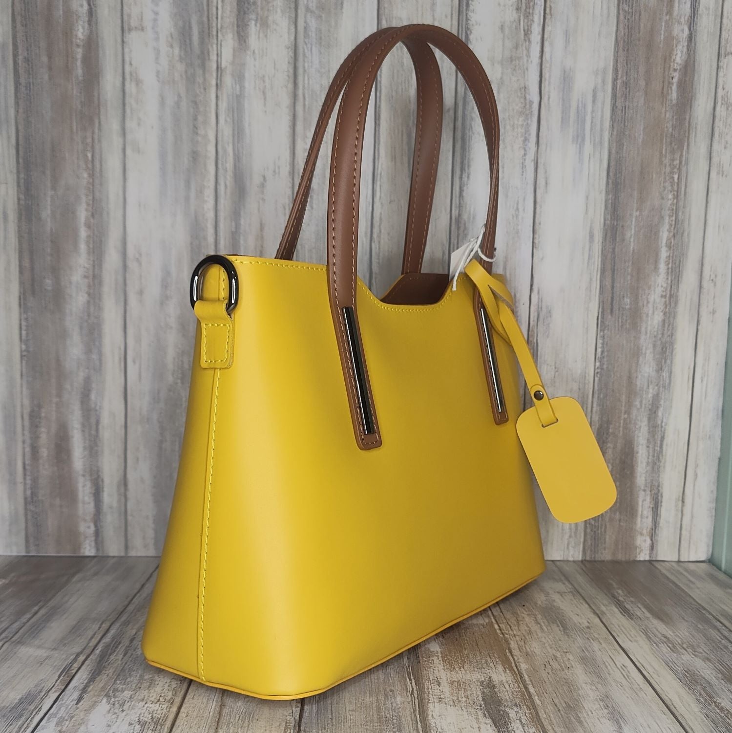 Elevate your style with this stunning Italian leather double compartment handbag.  Its soft yet structured design looks beautiful and feels equally beautiful to wear. This is a classic design that will match with any outfit and is the perfect size for all your essential items. Get ready to make a statement with this fashionable and functional addition to your wardrobe.  We love this bag!