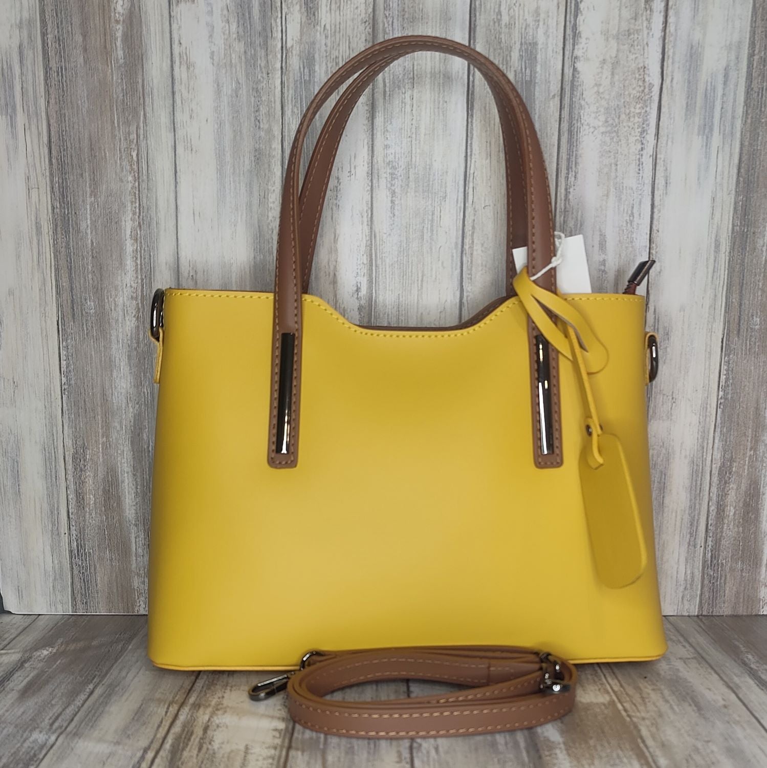 Elevate your style with this stunning Italian leather double compartment handbag.  Its soft yet structured design looks beautiful and feels equally beautiful to wear. This is a classic design that will match with any outfit and is the perfect size for all your essential items. Get ready to make a statement with this fashionable and functional addition to your wardrobe.  We love this bag!