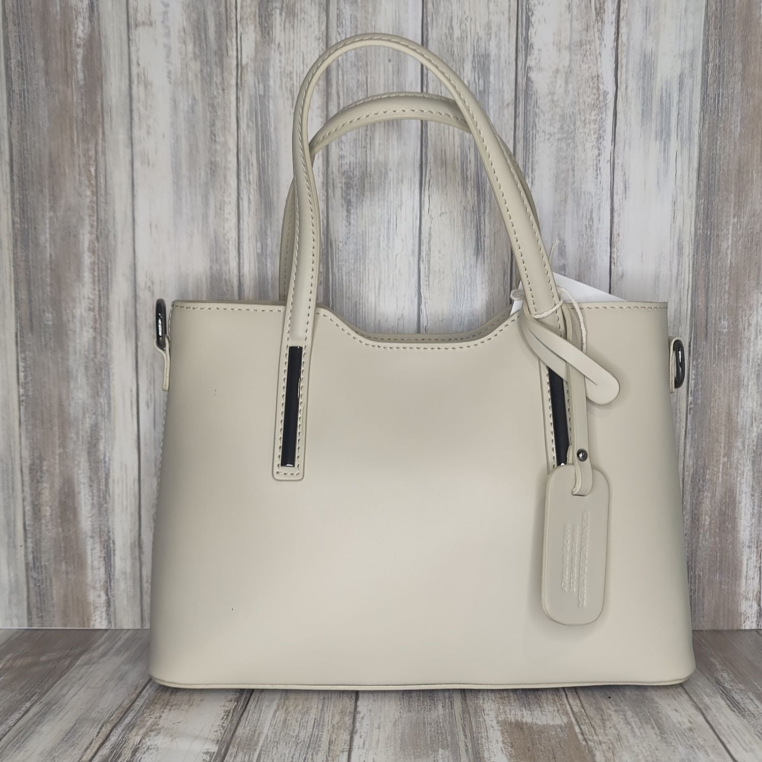 Elevate your style with this stunning Italian leather double compartment handbag.  Its soft yet structured design looks beautiful and feels equally beautiful to wear. This is a classic design that will match with any outfit and is the perfect size for all your essential items. Get ready to make a statement with this fashionable and functional addition to your wardrobe.  We love this bag!