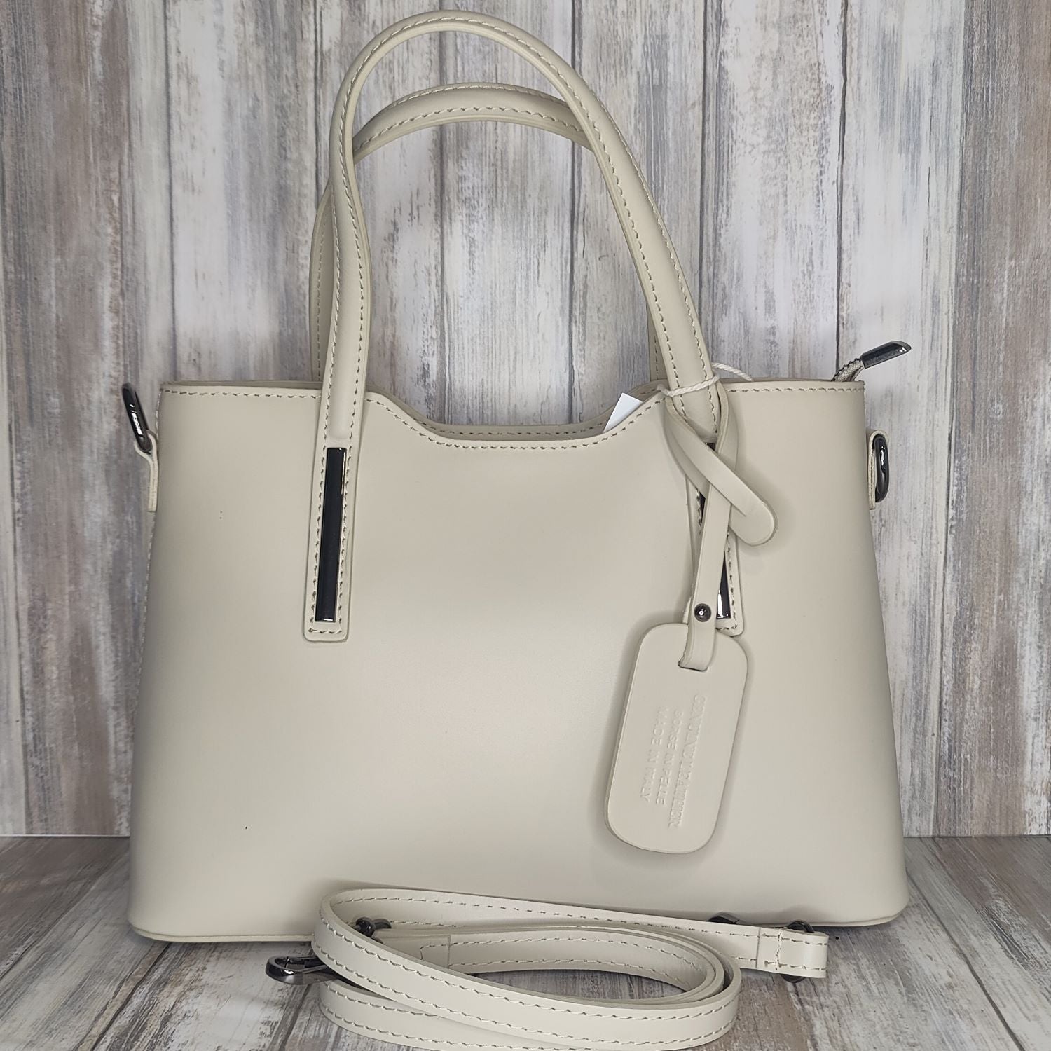 Elevate your style with this stunning Italian leather double compartment handbag.  Its soft yet structured design looks beautiful and feels equally beautiful to wear. This is a classic design that will match with any outfit and is the perfect size for all your essential items. Get ready to make a statement with this fashionable and functional addition to your wardrobe.  We love this bag!