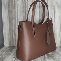 Elevate your style with this stunning Italian leather double compartment handbag.  Its soft yet structured design looks beautiful and feels equally beautiful to wear. This is a classic design that will match with any outfit and is the perfect size for all your essential items. Get ready to make a statement with this fashionable and functional addition to your wardrobe.  We love this bag!