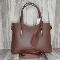 Elevate your style with this stunning Italian leather double compartment handbag.  Its soft yet structured design looks beautiful and feels equally beautiful to wear. This is a classic design that will match with any outfit and is the perfect size for all your essential items. Get ready to make a statement with this fashionable and functional addition to your wardrobe.  We love this bag!