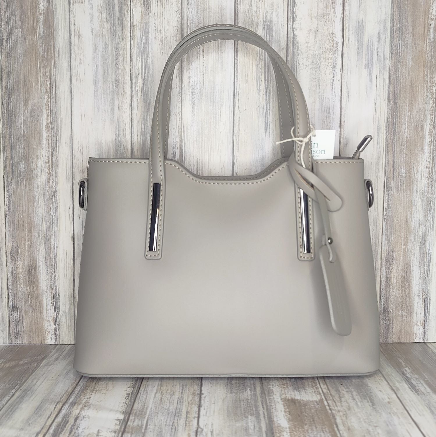 Elevate your style with this stunning Italian leather double compartment handbag.  Its soft yet structured design looks beautiful and feels equally beautiful to wear. This is a classic design that will match with any outfit and is the perfect size for all your essential items. Get ready to make a statement with this fashionable and functional addition to your wardrobe.  We love this bag!