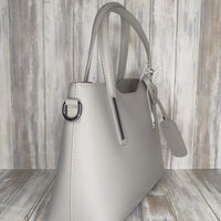 Elevate your style with this stunning Italian leather double compartment handbag.  Its soft yet structured design looks beautiful and feels equally beautiful to wear. This is a classic design that will match with any outfit and is the perfect size for all your essential items. Get ready to make a statement with this fashionable and functional addition to your wardrobe.  We love this bag!