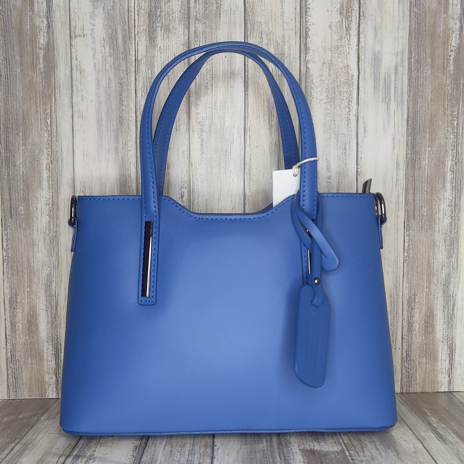 Elevate your style with this stunning Italian leather double compartment handbag.  Its soft yet structured design looks beautiful and feels equally beautiful to wear. This is a classic design that will match with any outfit and is the perfect size for all your essential items. Get ready to make a statement with this fashionable and functional addition to your wardrobe.  We love this bag!