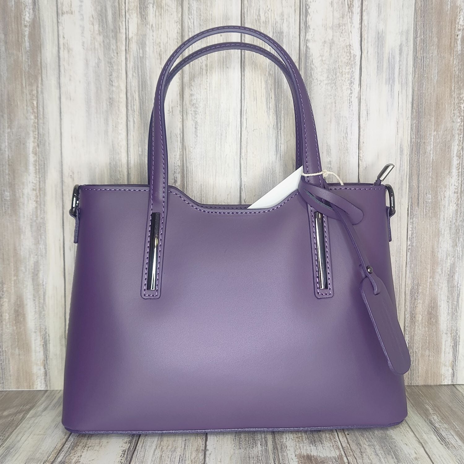 Elevate your style with this stunning Italian leather double compartment handbag.  Its soft yet structured design looks beautiful and feels equally beautiful to wear. This is a classic design that will match with any outfit and is the perfect size for all your essential items. Get ready to make a statement with this fashionable and functional addition to your wardrobe.  We love this bag!