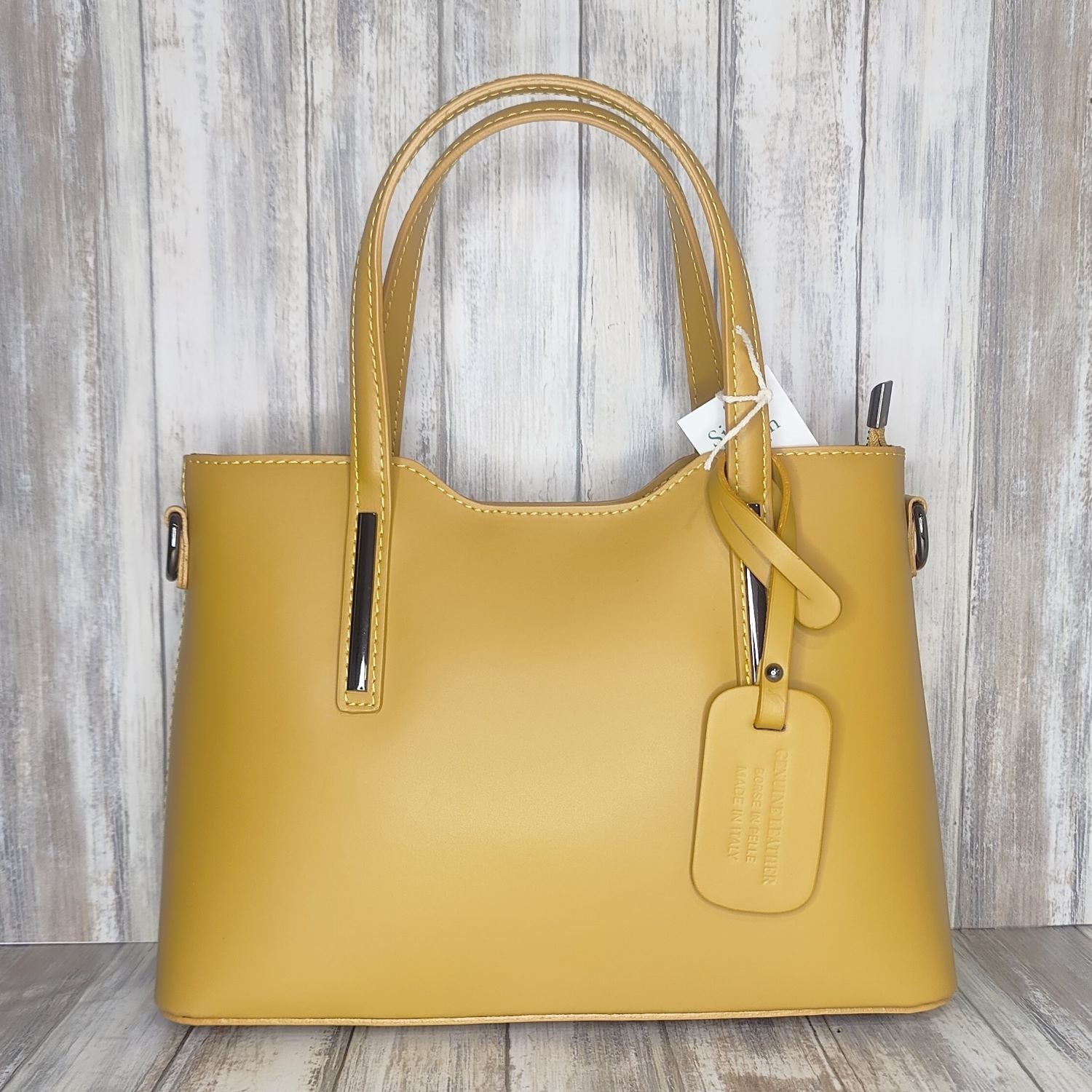 Elevate your style with this stunning Italian leather double compartment handbag.  Its soft yet structured design looks beautiful and feels equally beautiful to wear. This is a classic design that will match with any outfit and is the perfect size for all your essential items. Get ready to make a statement with this fashionable and functional addition to your wardrobe.  We love this bag!