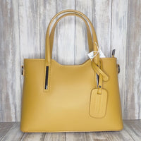 Elevate your style with this stunning Italian leather double compartment handbag.  Its soft yet structured design looks beautiful and feels equally beautiful to wear. This is a classic design that will match with any outfit and is the perfect size for all your essential items. Get ready to make a statement with this fashionable and functional addition to your wardrobe.  We love this bag!