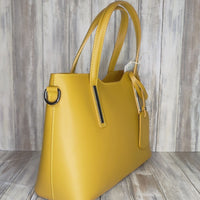 Elevate your style with this stunning Italian leather double compartment handbag.  Its soft yet structured design looks beautiful and feels equally beautiful to wear. This is a classic design that will match with any outfit and is the perfect size for all your essential items. Get ready to make a statement with this fashionable and functional addition to your wardrobe.  We love this bag!