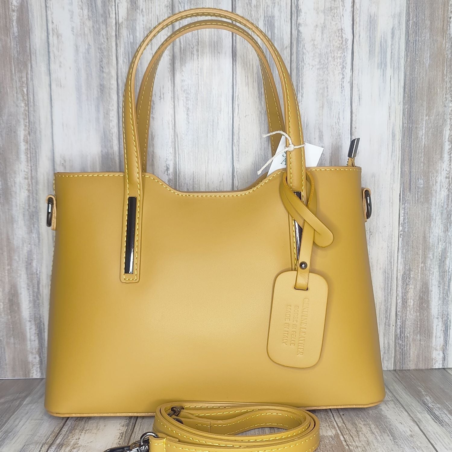 Elevate your style with this stunning Italian leather double compartment handbag.  Its soft yet structured design looks beautiful and feels equally beautiful to wear. This is a classic design that will match with any outfit and is the perfect size for all your essential items. Get ready to make a statement with this fashionable and functional addition to your wardrobe.  We love this bag!