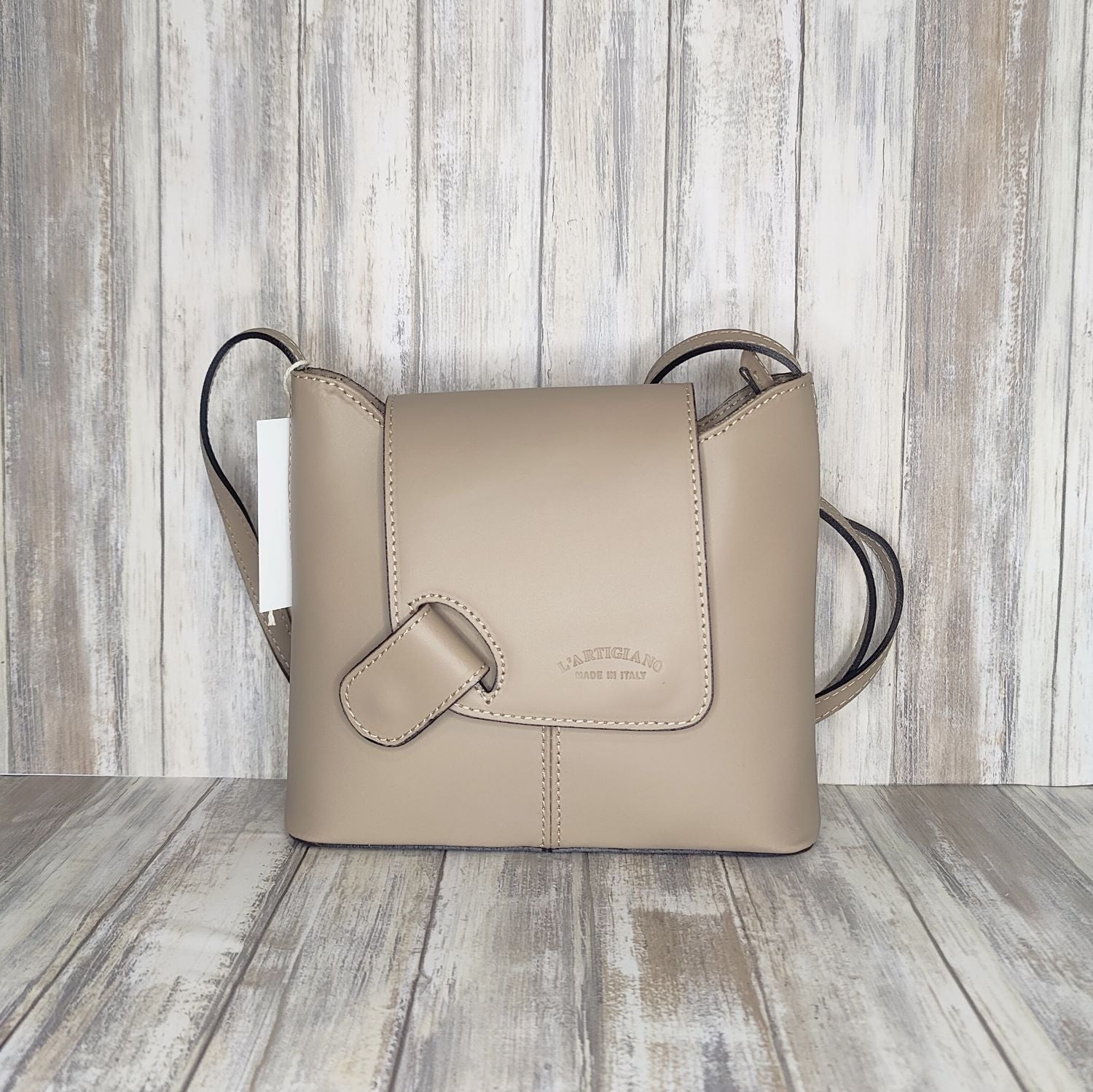 Crafted with Italian leather, this cross body bag features a magnetic dot and zip closure and an adjustable strap for a stylish look.       Back Zip Pocket   Internal Slip Pocket   Silver Hardware   H20cm x W24cm x D6cm